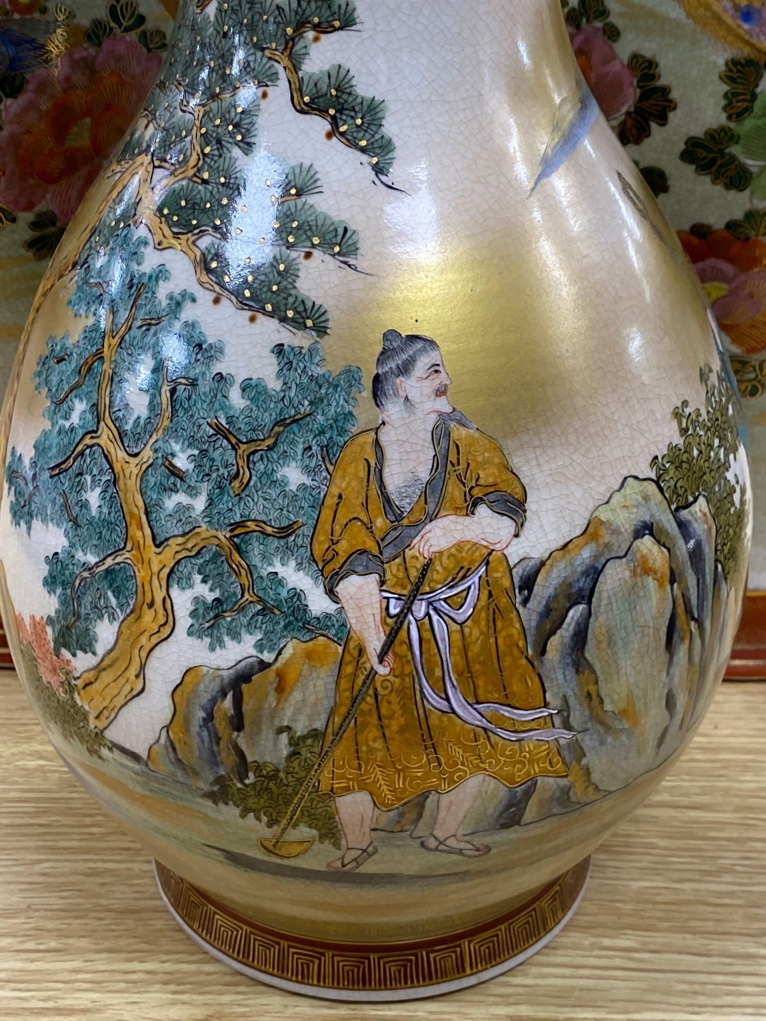 A pair of Japanese satsuma baluster vases, height 46cm, and a satsuma bulbous vase, height 37cm